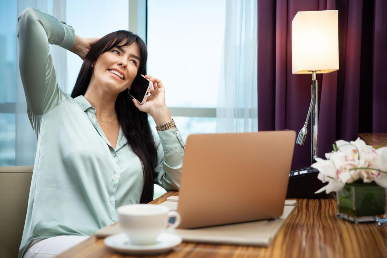 Pullman Jumeirah Lakes Towers Hotel y Residencia Dubái Exterior foto A woman using a mobile phone